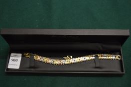 A multi-coloured metal articulated bracelet.