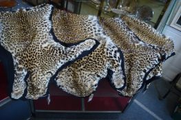 Four leopard skins.