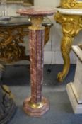 A pair of rouge marble octagonal shaped columns.