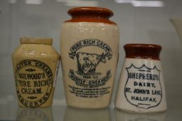 A Huntly creamery stoneware pot together with two similar small cream pots for Manchester creamery