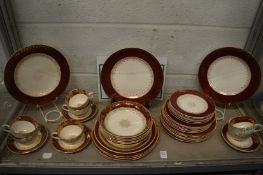 Quantity of J & G Meakin burgundy and gilt decorated dinnerware.