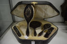 A cased five piece silver and tortoiseshell dressing table set (faults).