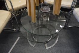 A stylish chrome and glass two-tier circular coffee table (faults).