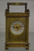 A brass carriage clock with ornate case.