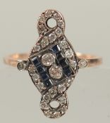 UNHALLMARKED ROSE GOLD ART NOUVEAU STYLE RING SET WITH CALIBRE CUT SAPPHIRES AND RBC DIAMONDS.