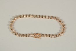 A 9ct ROSE GOLD DIAMOND LINE BRACELET. Approx. 5ct of diamonds.