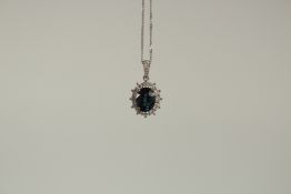 A FINE QUALITY SAPPHIRE AND DIAMOND PENDANT on a white gold chain.
