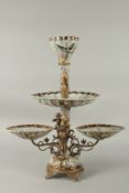 A LARGE THREE TIER PORCELAIN AND GILT METAL TABLE CENTREPIECE with cupids and flowers. 52cms high.