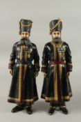 A LARGE PAIR OF RUSSIAN BRONZE STANDING FIGURES wearing three medals. Signed on feet. 38cms high.