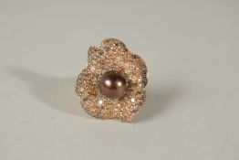 AN 18ct GOLD RING SET WITH NATURAL BROWN DIAMONDS AND TAHITIAN BLACK SOUTH SEA PEARLS.