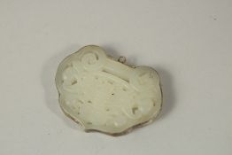 A PIERCED WHITE JADE PENDANT.