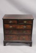 AN EARLY 18TH CENTURY OAK AND WALNUT STRAIGHT FRONT CHEST of two short and three long graduated