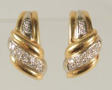 A PAIR OF 18ct GOLD AND DIAMOND EARRINGS.