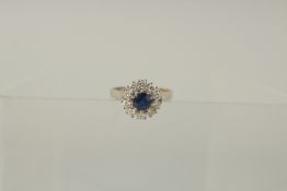AN 18ct YELLOW GOLD, SAPPHIRE AND DIAMOND CLUSTER RING.