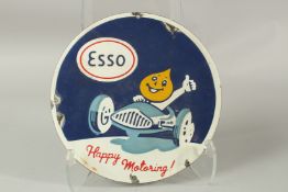 AN ESSO HAPPY MOTORING ENAMEL SIGN. 27cms diameter.