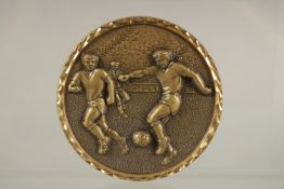 A FOOTBALL BRONZE MEDALLION, boxed.