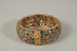 A GOOD GOLD MULTI-STONE BANGLE.
