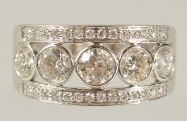 AN 18ct WHITE GOLD FIVE STONE DIAMOND RING with diamond band.