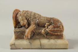 THE LION OF LUCERNE. A SOAPSTONE CARVING OF A LION on a marble base. See label on reverse. 9ins