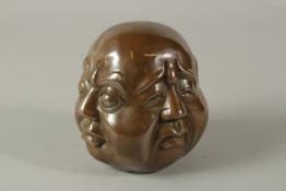 A BRONZE FOUR-FACED BUDDHA. 11cms high.