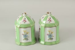 A PAIR OF SEVRES DESIGN PORCELAIN SQUARE GREEN LIDDED BOXES AND COVERS with panels of flowers and
