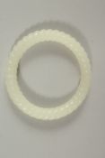 A CHINESE WHITE JADE TWIST BANGLE. 8cms diameter.