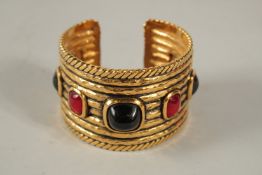 A HEAVY CHANEL GILT METAL BANGLE set with seven cabochon stones.