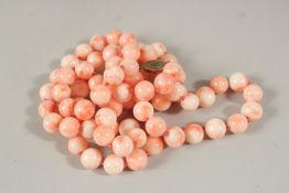 A CORAL BEAD NECKLACE WITH EIGHTY BEADS. 96cms long.