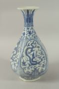 A CHINESE BLUE AND WHITE PORCELAIN OCTAGONAL VASE decorated with panels of dragons. 35cms high.