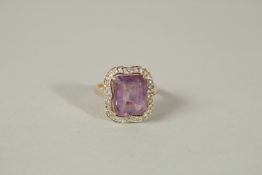 A 9ct GOLD, AMETHYST AND DIAMOND CLUSTER RING.