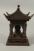 A CHINESE BRONZE BUDDHA TEMPLE. 11cms high.