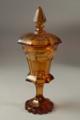 A VERY GOOD BOHEMIAN AMBER TINTED GOBLET AND COVER etched with eight circular panels of animals,