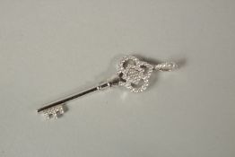 AN 18ct WHITE GOLD KEY PENDANT.