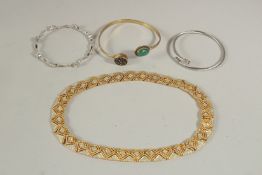 A GILT AND DIAMANTE NECKLACE AND THREE BRACELETS.