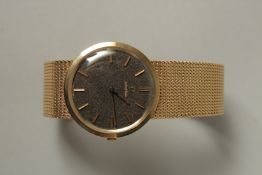 A GENTLEMAN'S 9ct OMEGA WRISTWATCH AND BRACELET in an Omega box, with papers. Approx. 53grms.