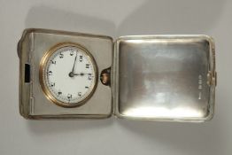 AN EDWARDIAN ENGINE TURNED TRAVELLING FOLDING WATCH CASE, Birmingham 1922, and a POCKET WATCH.