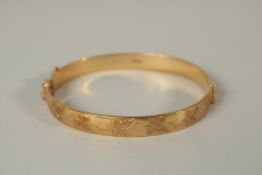 A 9ct GOLD HINGED BANGLE. 25grms.