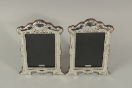A PAIR OF SILVER GOTHIC DESIGN PHOTOGRAPH FRAMES. 20cms x 14cms.