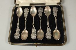 A SET OF SIX .900 SILVER ROSE DESIGN TEASPOONS in a fitted case.