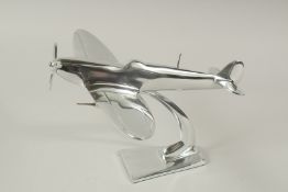 A PLATED SPITFIRE on a stand. 20cms high.