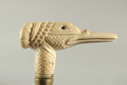 A WALKING STICK with a carved bone handle of a duck.