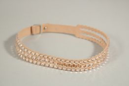 A SWAROVSKI TRIPLE ROW DIAMANTE AND LEATHER NECKLACE, boxed.
