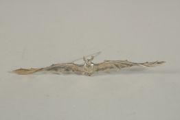 A SILVER BAT BROOCH. 11cms long.