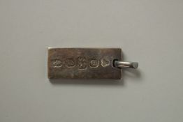 A SILVER ONE OUNCE INGOT.