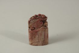 A CHINESE CARVED HARDSTONE DRAGON SEAL. 8cms high.