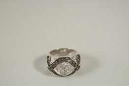 A GOOD SILVER DIAMANTE AND BLACK STONE RING, boxed.