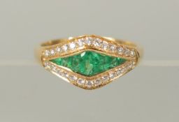 AN 18ct YELLOW GOLD, EMERALD AND DIAMOND HALLMARKED RING.