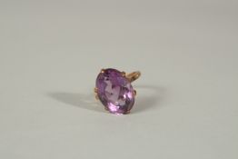 A 9ct YELLOW GOLD AND LARGE AMETHYST RING.