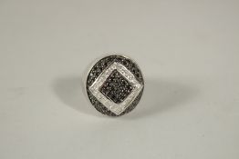 A GOOD SILVER DIAMANTE AND BLUE STONE RING, boxed.