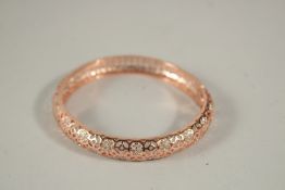 A PIERCED GILT AND DIAMANTE BRACELET, boxed.